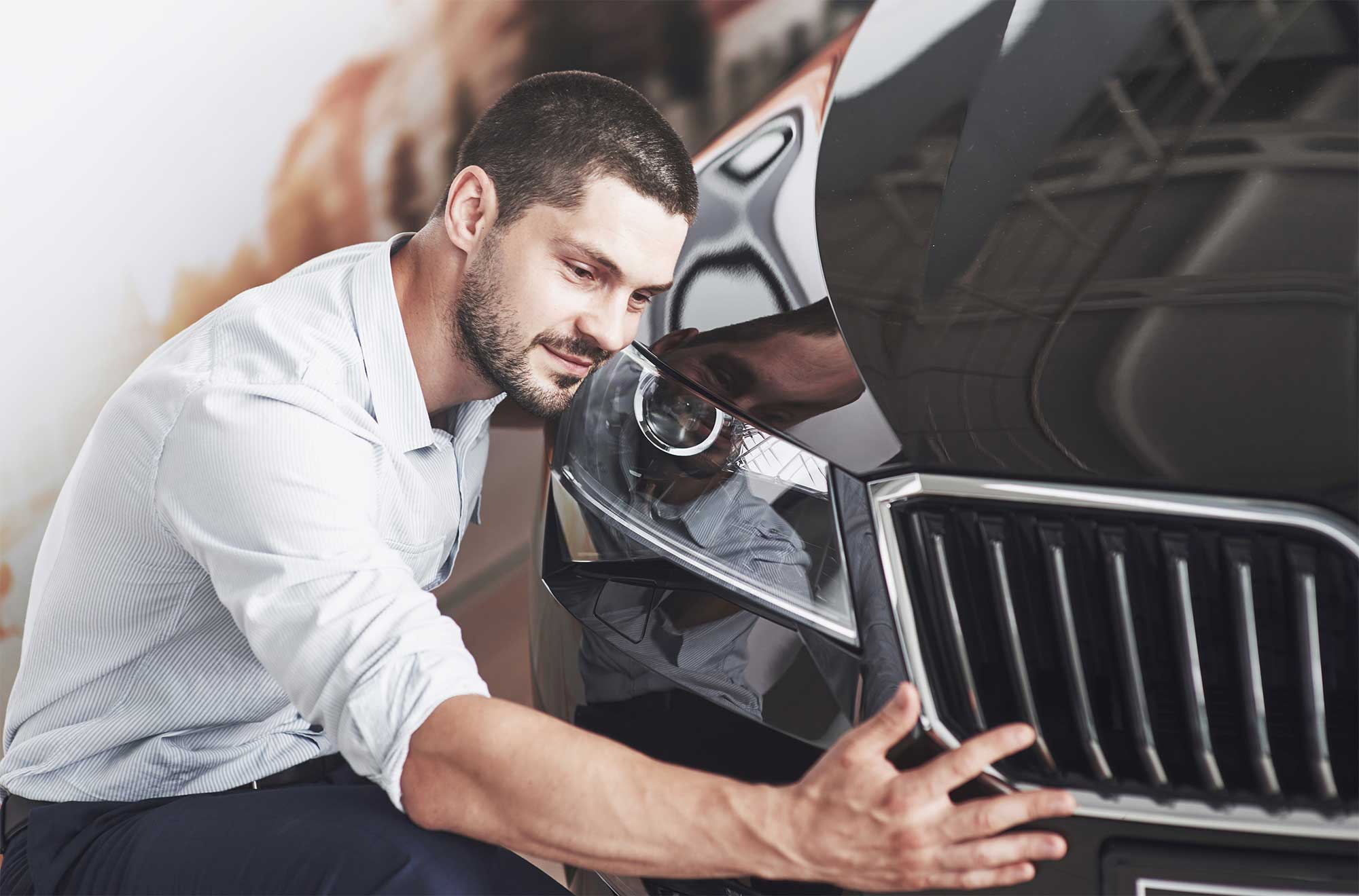 portrait-happy-smiling-man-who-chooses-new-car-cabin